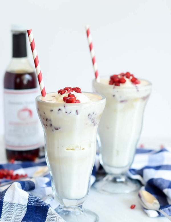 Picture of two ice cream glasses filled with vanilla pice cream and pomegranate soda