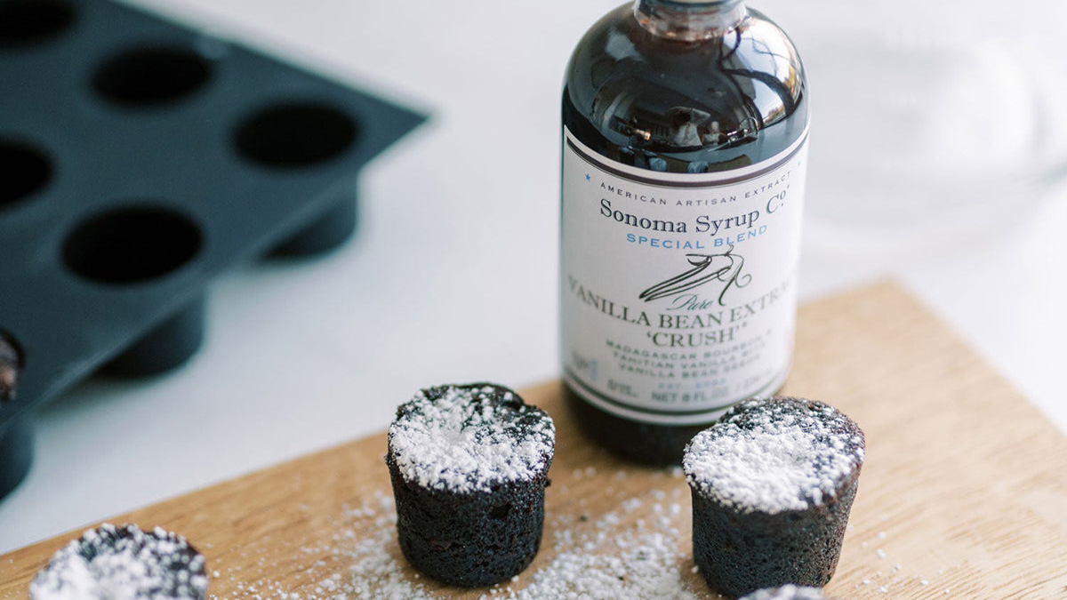 Pure vanilla bean extract crush next to dark chocolate brownie bites